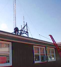 Phillip/AK1H, on the roof removing bolts from the tower support.