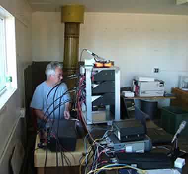 Henry/KT1J, with the transverter rack that he built for VHF contesting.